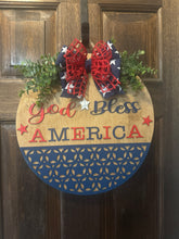 Load image into Gallery viewer, God Bless America Door Hanger | 19" Patriotic Round Sign | Hand Painted Birch Wood | 4th of July Front Door Decor