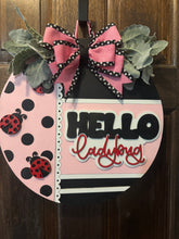 Load image into Gallery viewer, Hello Pink &amp; Black Door Hanger – Hand-Painted 18&quot; Laser-Cut Wood Round – Front Door Decor, Year-Round Welcome Sign, Modern Entryway Accent
