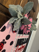 Load image into Gallery viewer, Hello Pink &amp; Black Door Hanger – Hand-Painted 18&quot; Laser-Cut Wood Round – Front Door Decor, Year-Round Welcome Sign, Modern Entryway Accent
