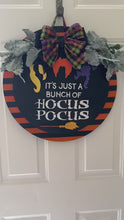 Load and play video in Gallery viewer, "Hocus Pocus" Halloween Door Hanger | Witch Hair Wood Sign with Plaid Bow | Orange &amp; Black Striped Round Sign | Fall Front Door Decor
